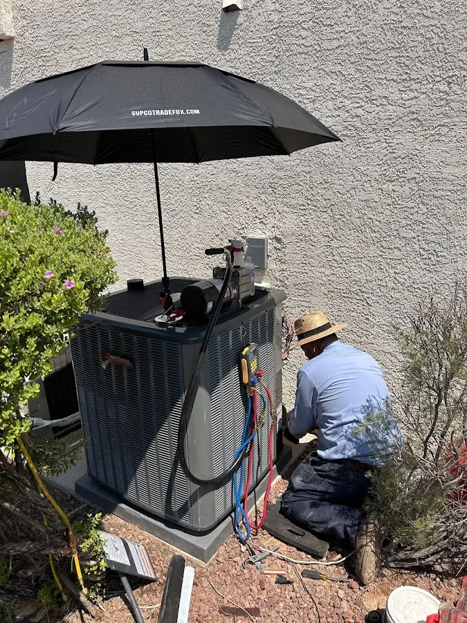 HVAC technician performing outdoor AC maintenance in Hopatcong